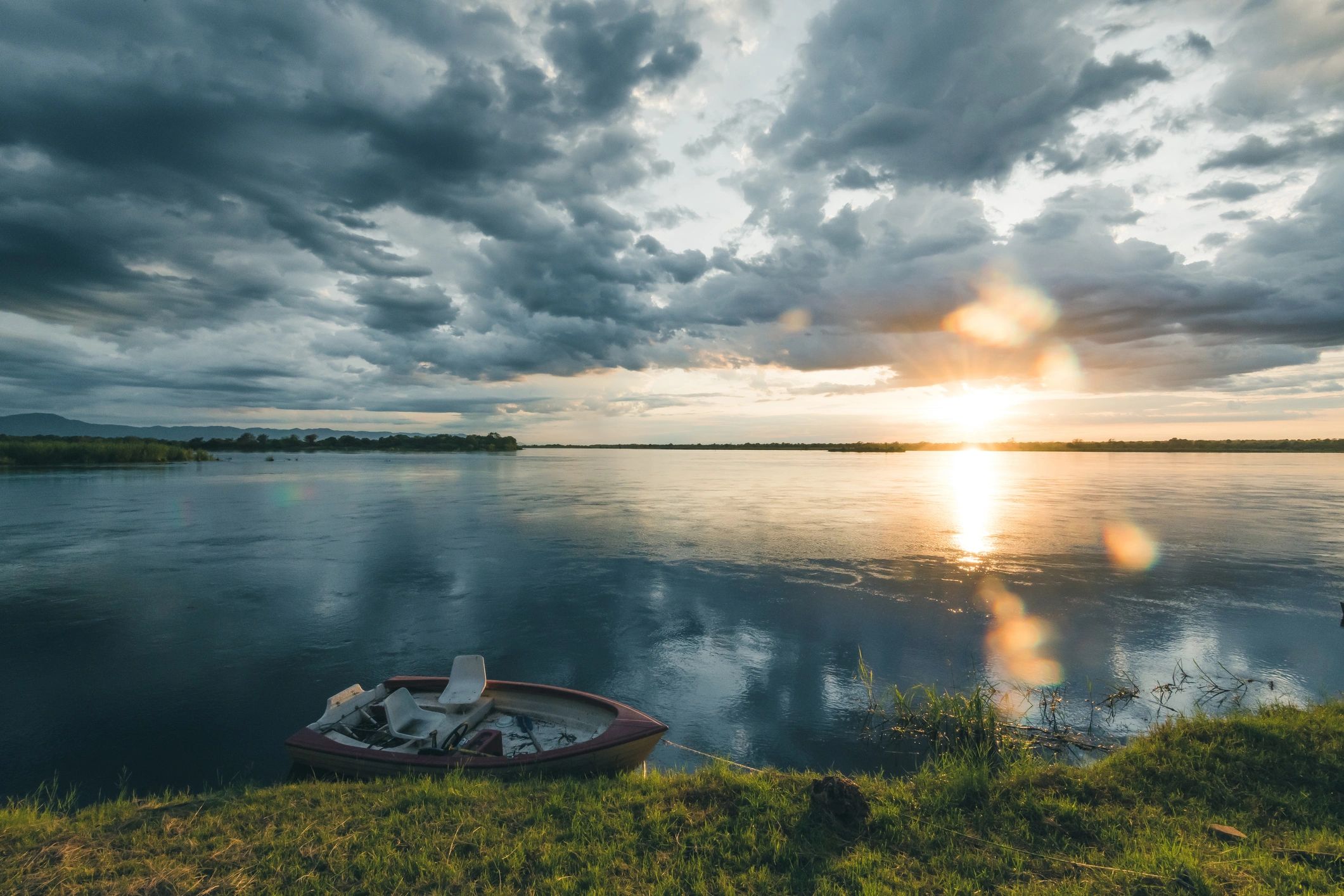 Fishing boat and tackle setting by the lake at sunrise