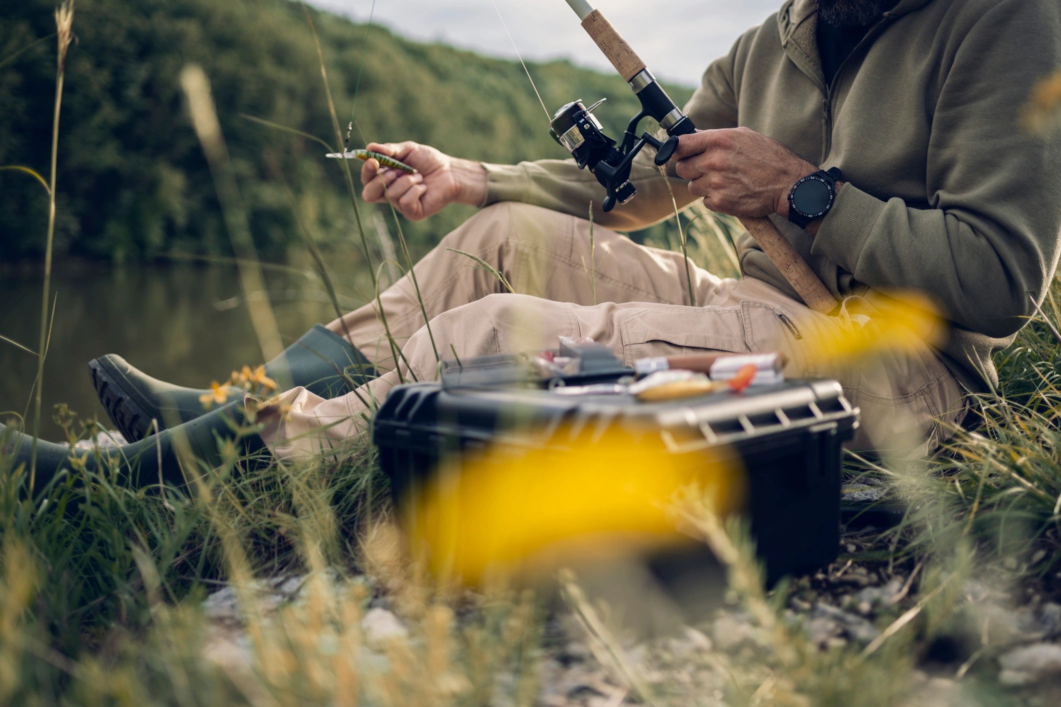 Hands preparing a fishing lure outdoors